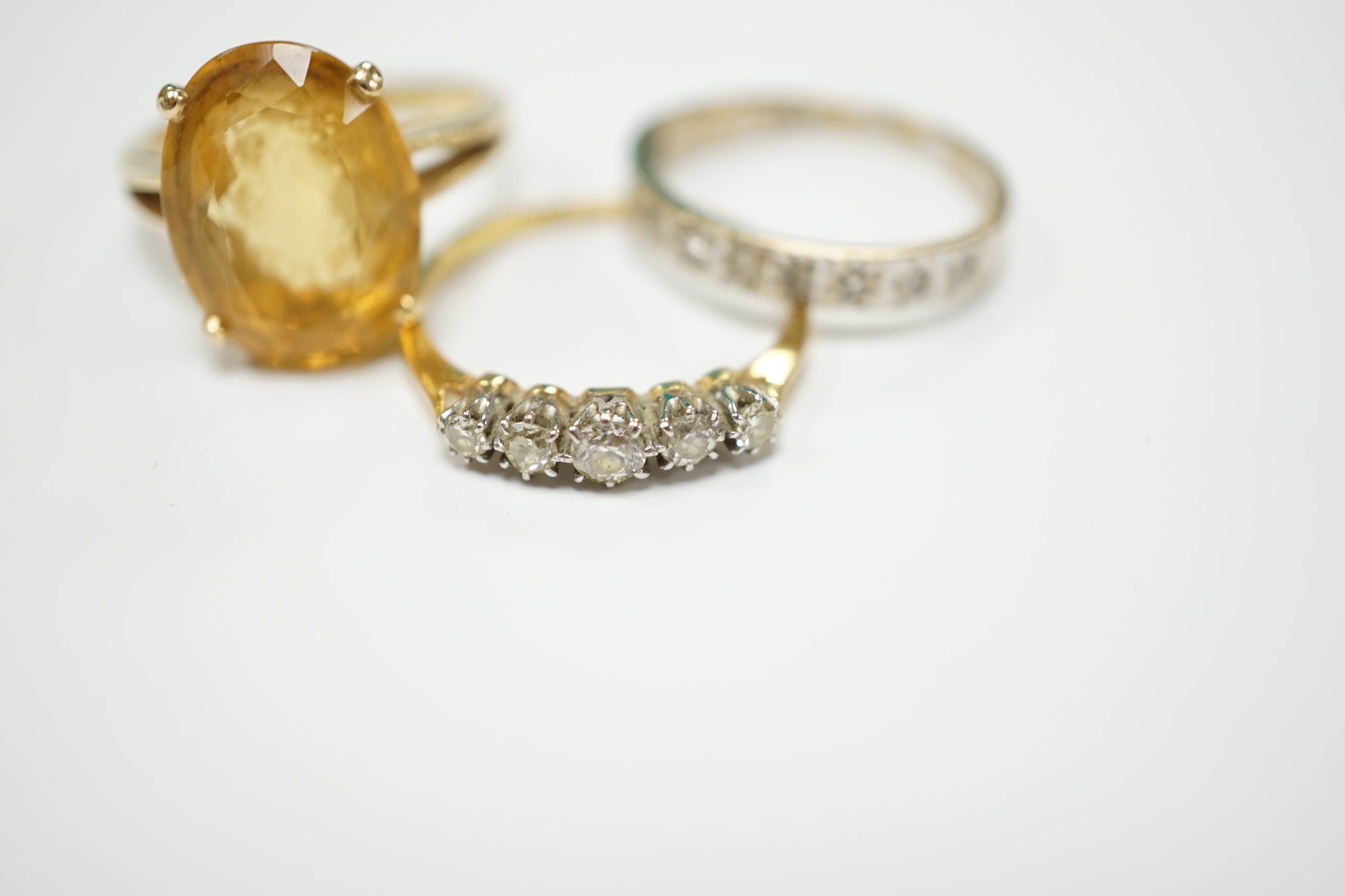 An 18ct and graduated five stone diamond set half hoop ring, size P/Q, one other 18ct and diamond chip set half hoop ring, gross weight 4.8 grams and a 14k and citrine set dress ring, gross weight 5.4 grams.